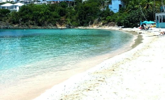 The white-sand curve and calm turquoise water of Secret Harbor beach, St. Thomas